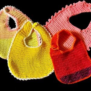 Baby Bibs Set of 4. Ages 0-6 months old. Buttons in the back. Washable in cold.